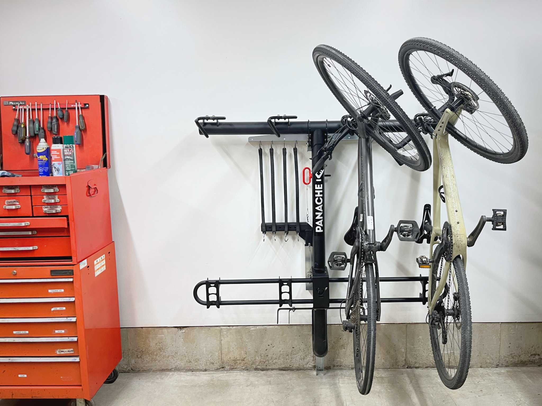 Rackarack wallmount installed on a wall with vertical bike rack and bikes attached to it for storage
